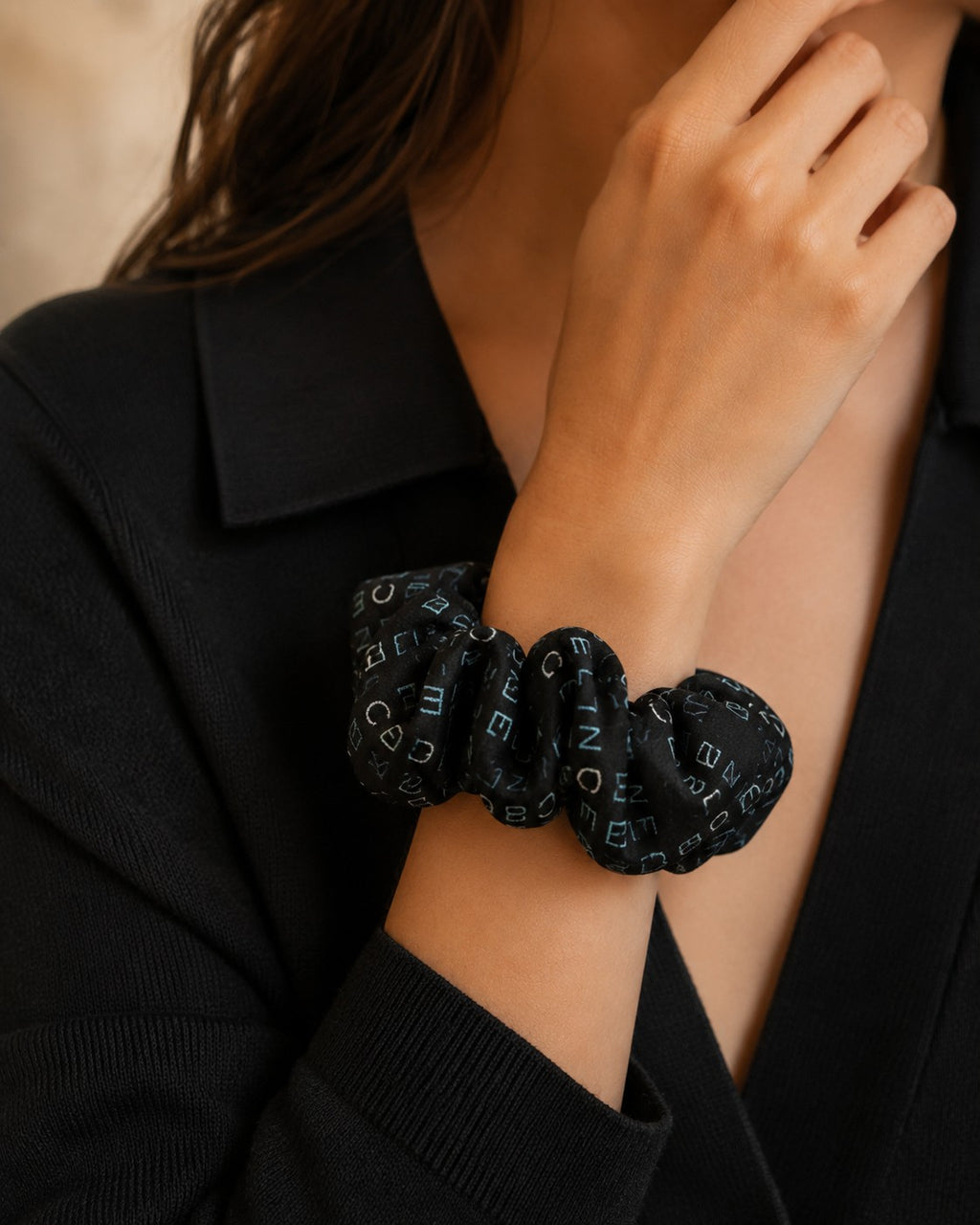 Second Soie handmade black scrunchie crafted from repurposed Celine scarf fabric with blue and ivory logo lettering.