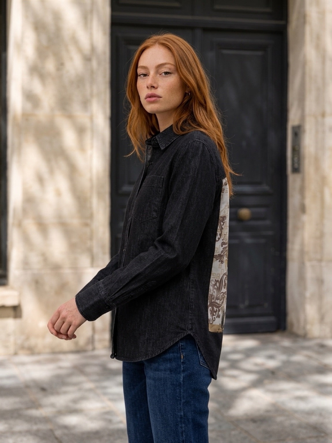 Second Soie model wearing a washed-black denim overshirt with an ivory and gold floral scarf panel on the back
