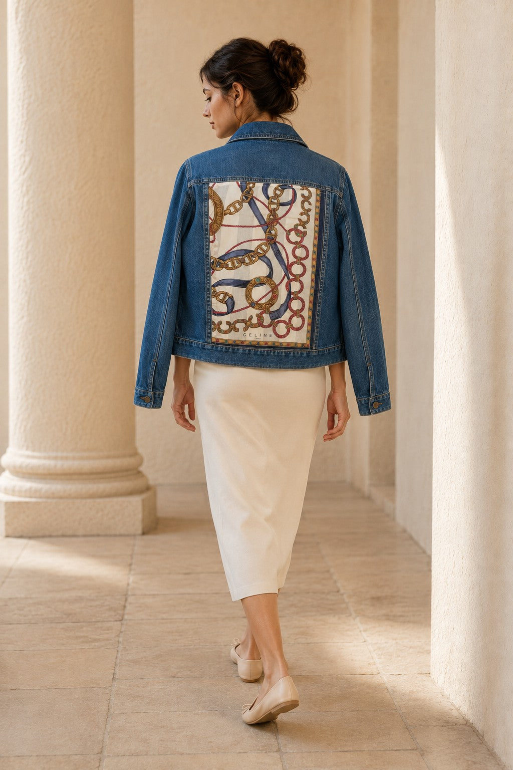 Second Soie cropped denim jacket with vintage Celine equestrian scarf back panel, worn by a woman in a cream skirt.
