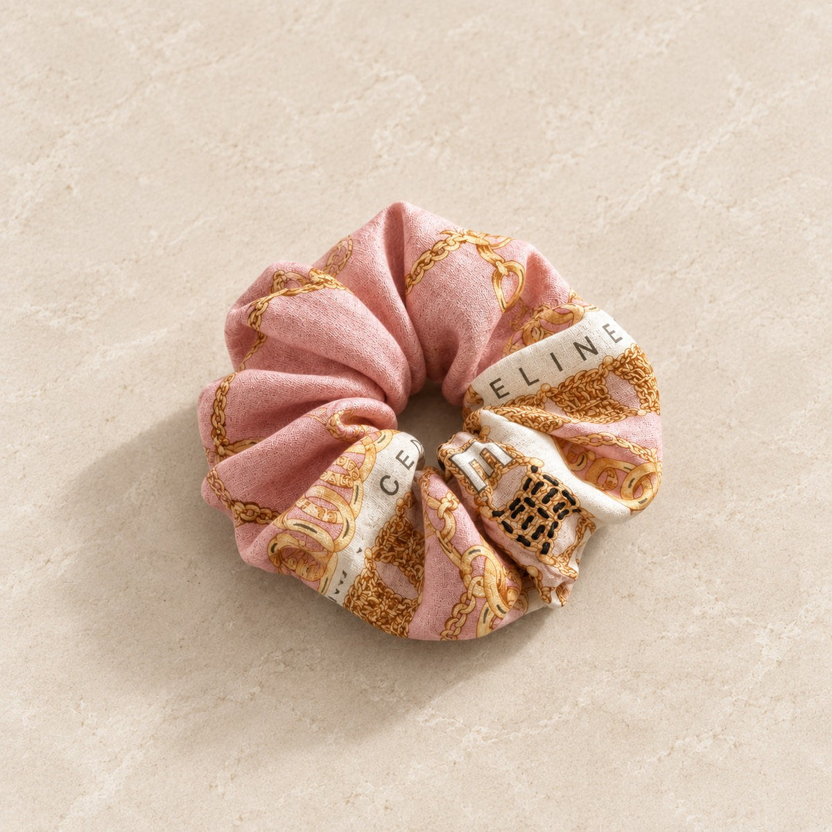 Second Soie jumbo scrunchie in blush pink and ivory with vintage Celine equestrian chain print and gold accents.