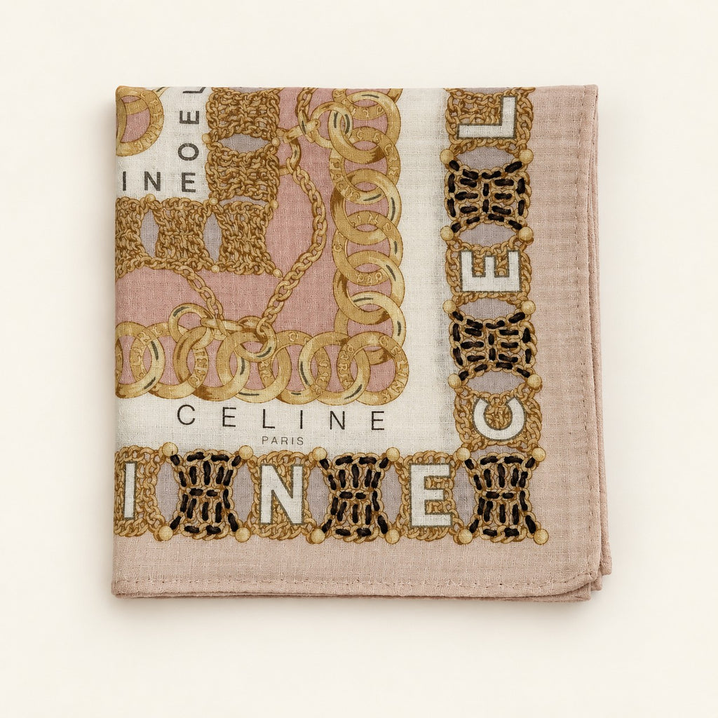Second Soie jumbo scrunchie made from a vintage Celine cotton scarf in ivory, blush, gold, and black chain print.