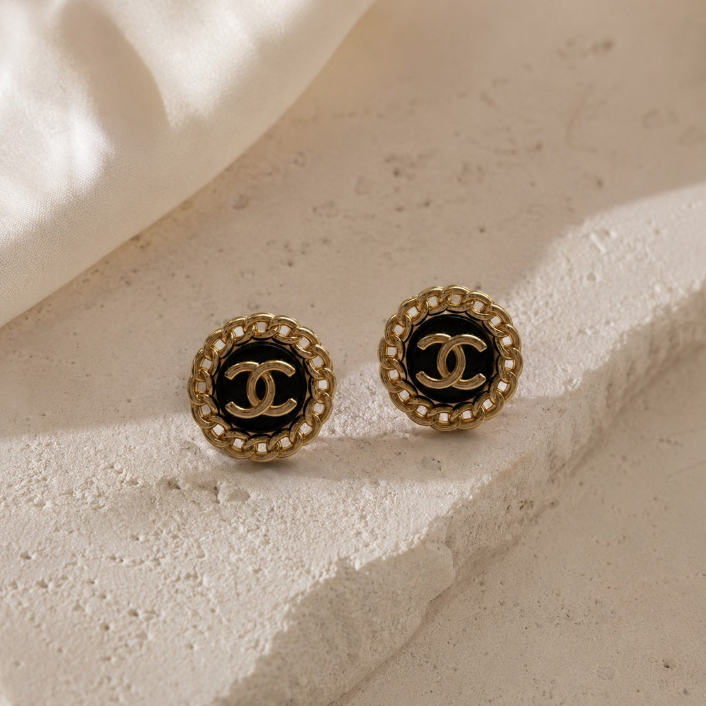 Second Soie vintage Chanel button earrings with black enamel, gold-tone chain border, and interlocking CC logo.