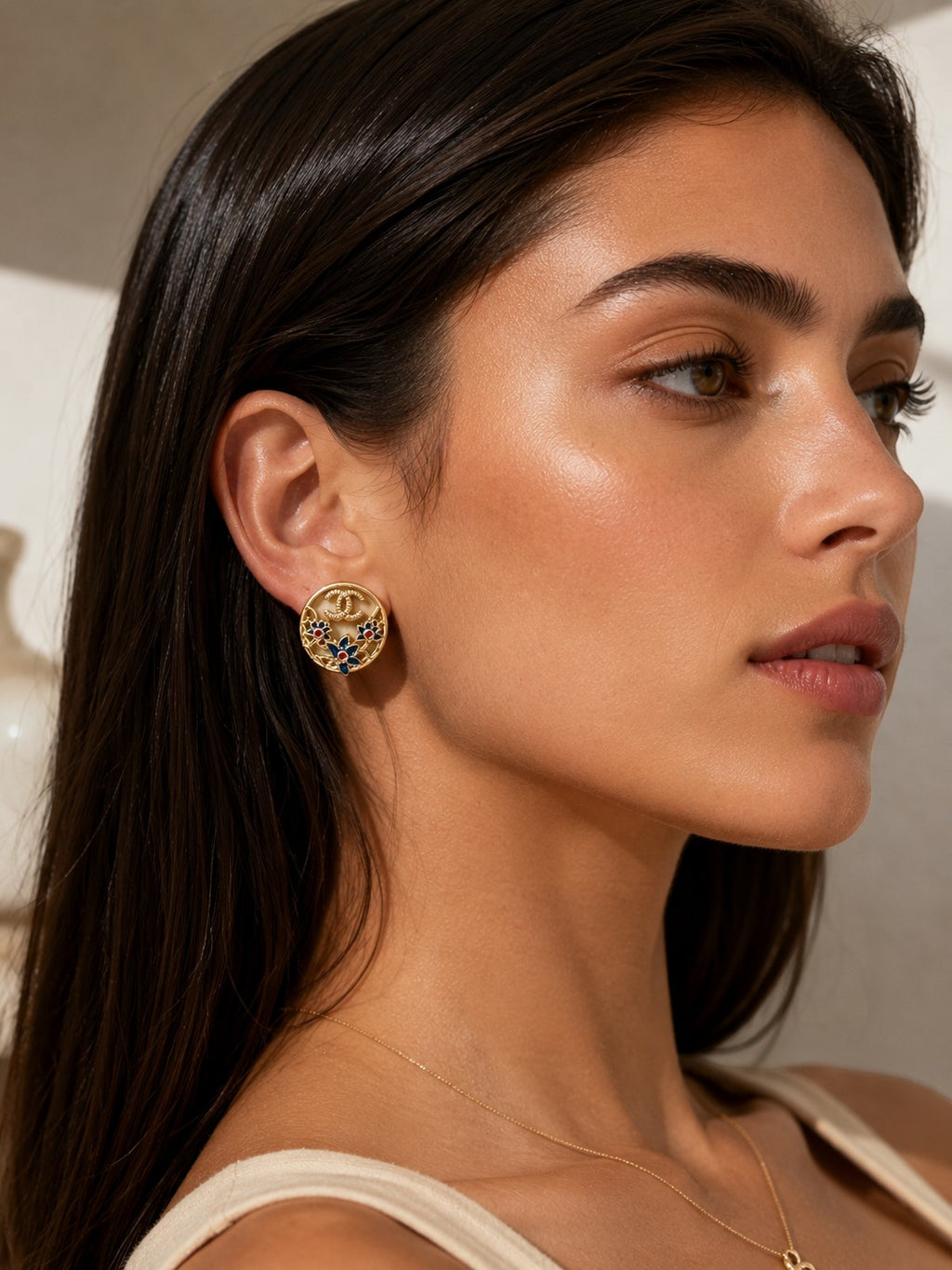 Second Soie vintage Chanel button earrings featuring gold CC logo with navy blue and red floral enamel on a model