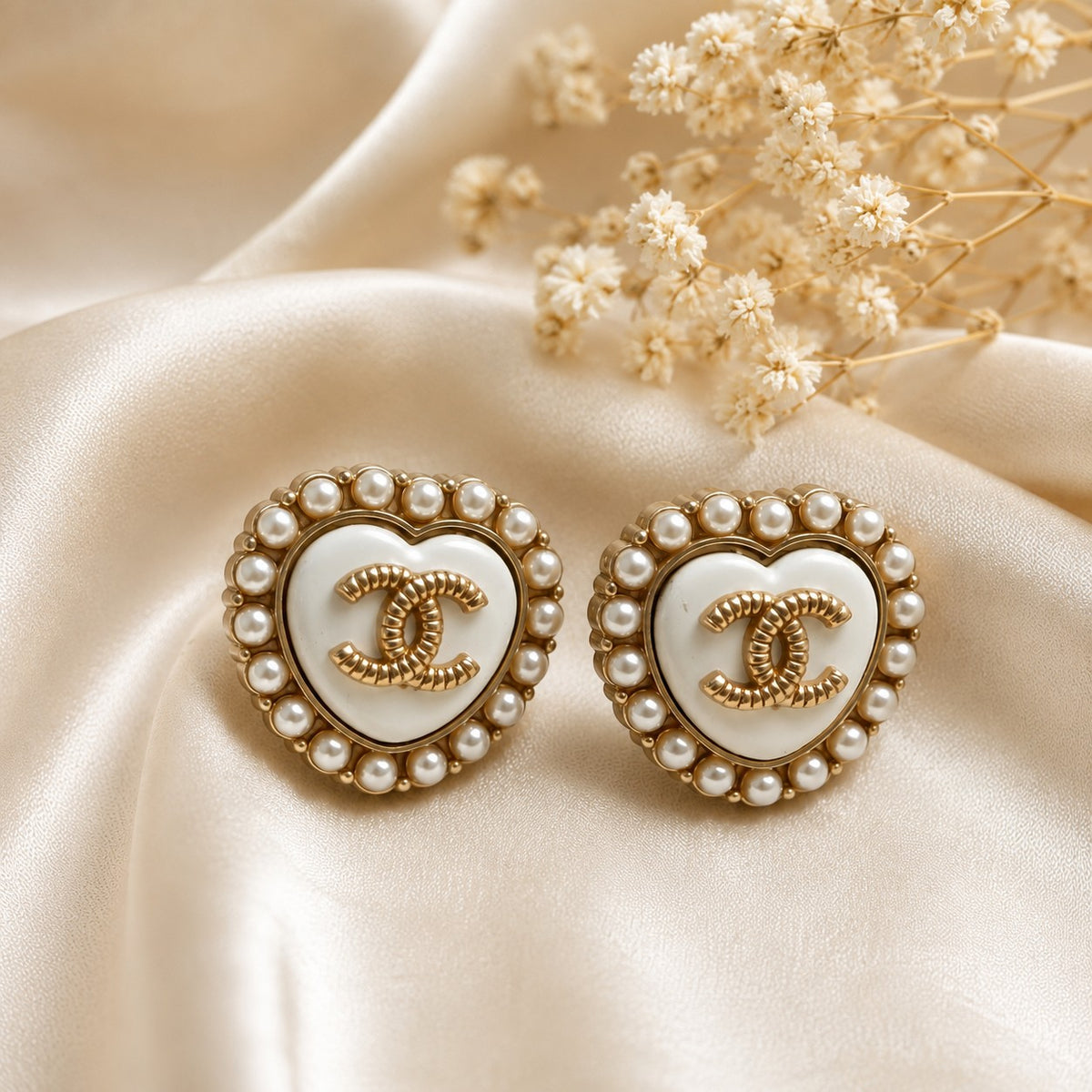 Second Soie vintage Chanel heart button earrings with ivory enamel, faux pearl halo, and gold CC logo on silk fabric.