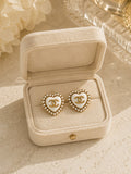 Second Soie vintage Chanel heart button earrings with ivory enamel, faux pearl halo, and gold CC logo in a velvet box