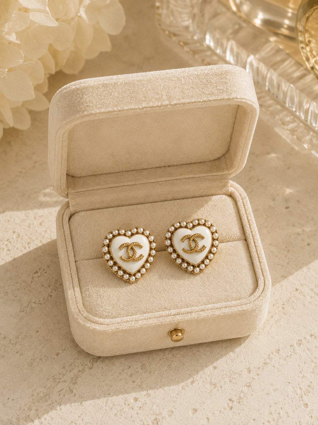 Second Soie vintage Chanel heart button earrings with ivory enamel, faux pearl halo, and gold CC logo in a velvet box