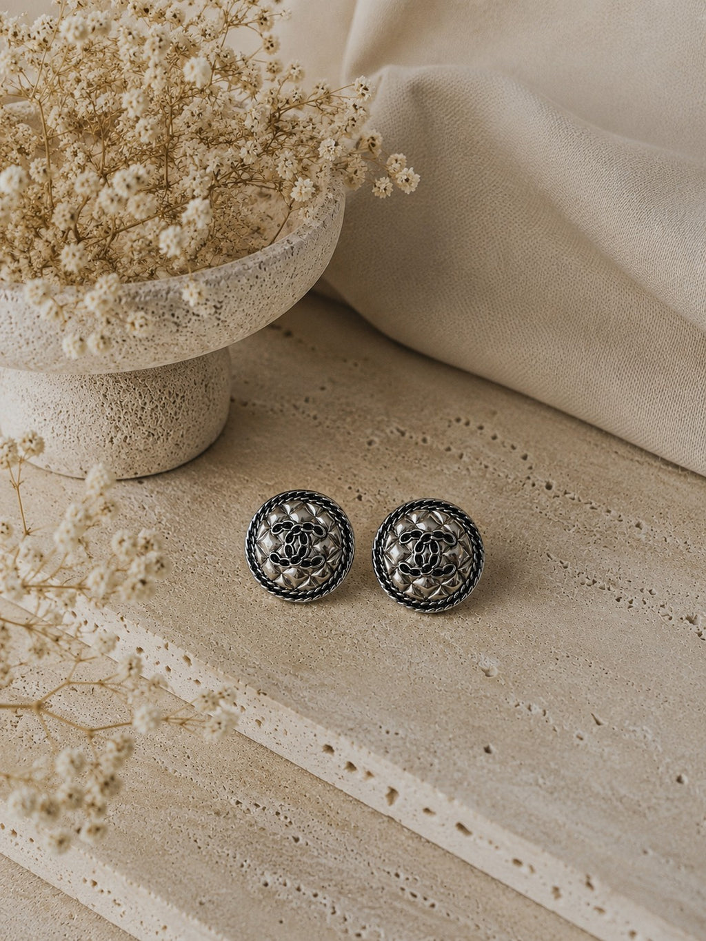 Second Soie vintage Chanel quilted silver stud earrings with interlocking CC motif and braided border on stone base.