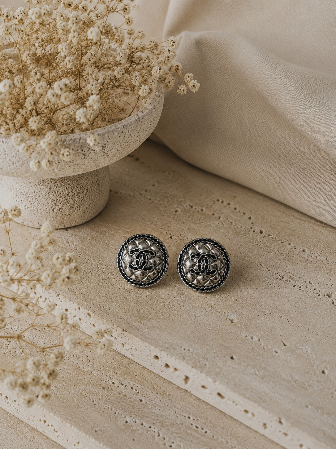 Second Soie vintage Chanel quilted silver stud earrings with interlocking CC motif and braided border on stone base.
