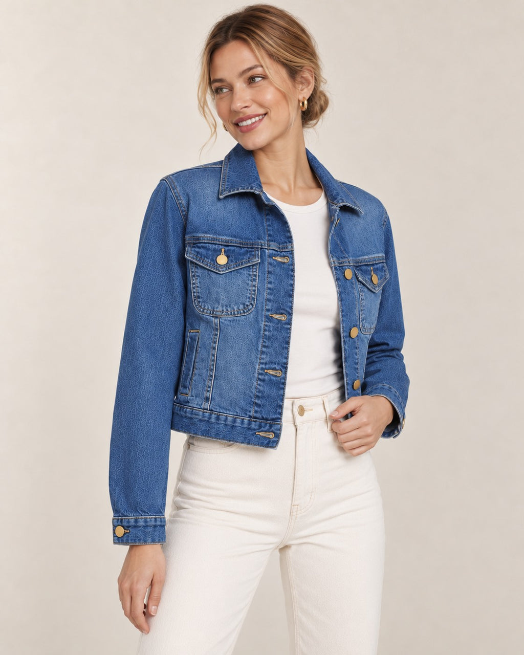 Second Soie cropped medium-wash denim jacket with gold buttons worn by a model in a white top and cream trousers