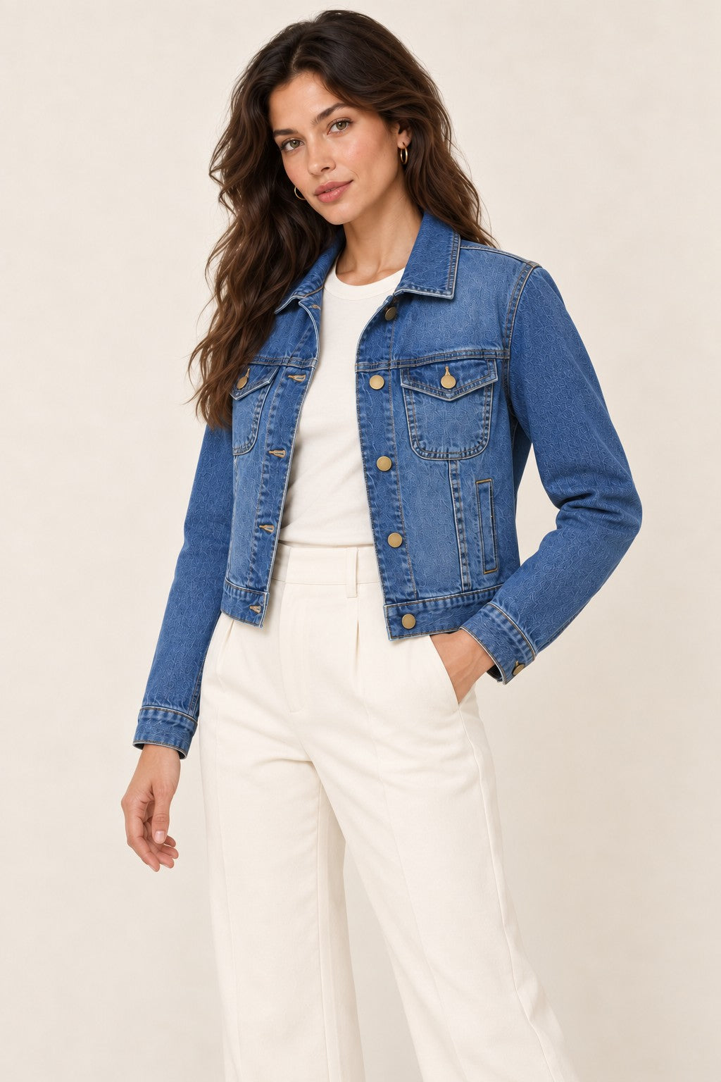 Second Soie medium-wash denim jacket with brass buttons worn by a model with white trousers