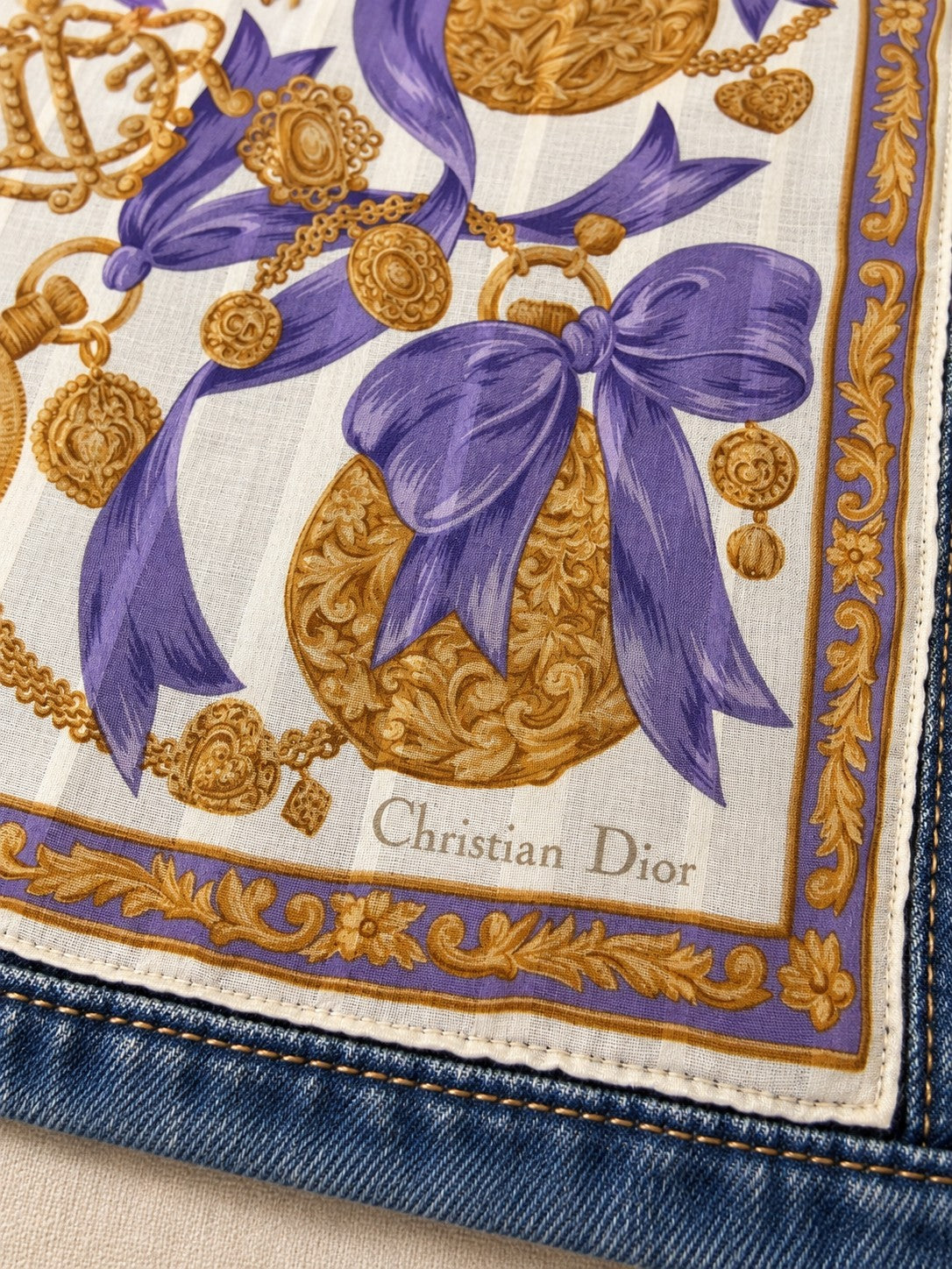 Second Soie reimagined denim jacket featuring a vintage Christian Dior scarf panel with purple bows and gold medallions