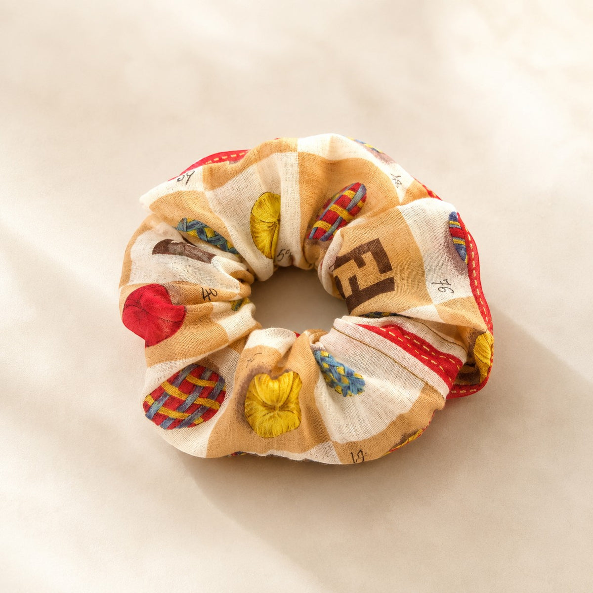Second Soie Fendi handkerchief scrunchie in cream and tan with brown emblem details and red border accents.