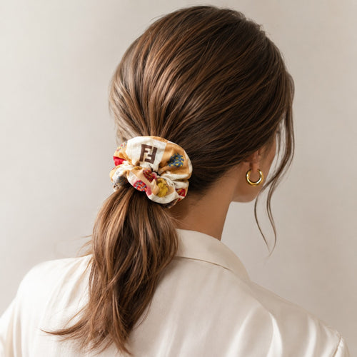 Second Soie scrunchie made from a cream and tan authentic Fendi handkerchief scarf worn in a woman's ponytail
