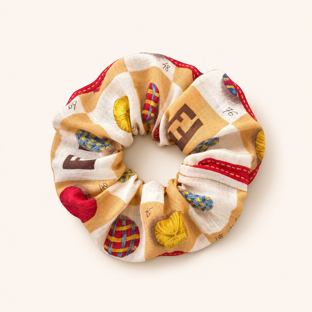 Second Soie Fendi handkerchief scrunchie in cream and tan with brown emblems and red, blue, and yellow accents