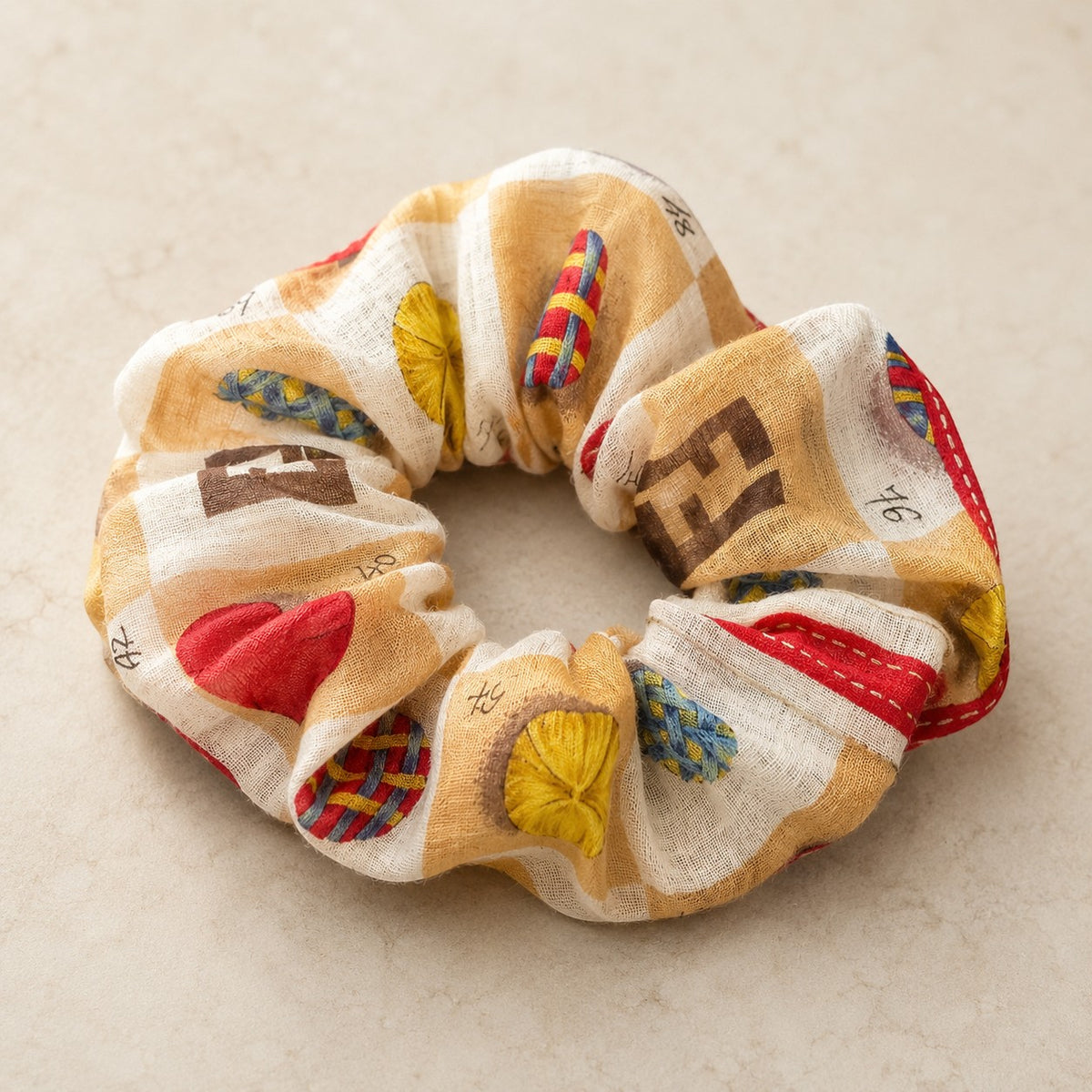 Second Soie Fendi handkerchief scrunchie in cream, tan, and brown with red, blue, and yellow patterned accents.