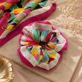 Second Soie handmade Givenchy scarf scrunchie in fuchsia with a multicolor floral print and designer logo border.