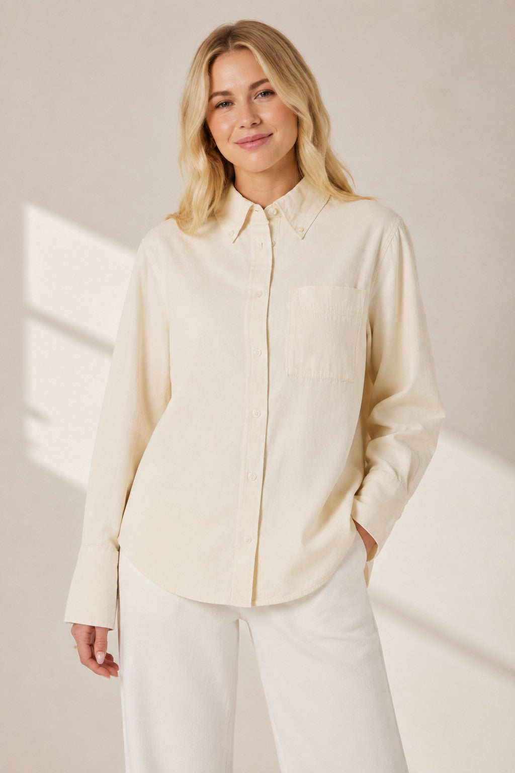 A blonde model wearing a Second Soie ivory cotton-denim overshirt with a button-down collar and chest pocket.