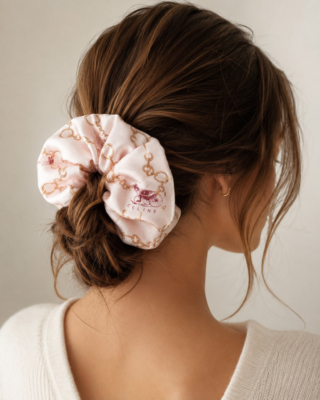 Second Soie jumbo silk scrunchie in blush with gold chain and burgundy equestrian print worn in a low bun