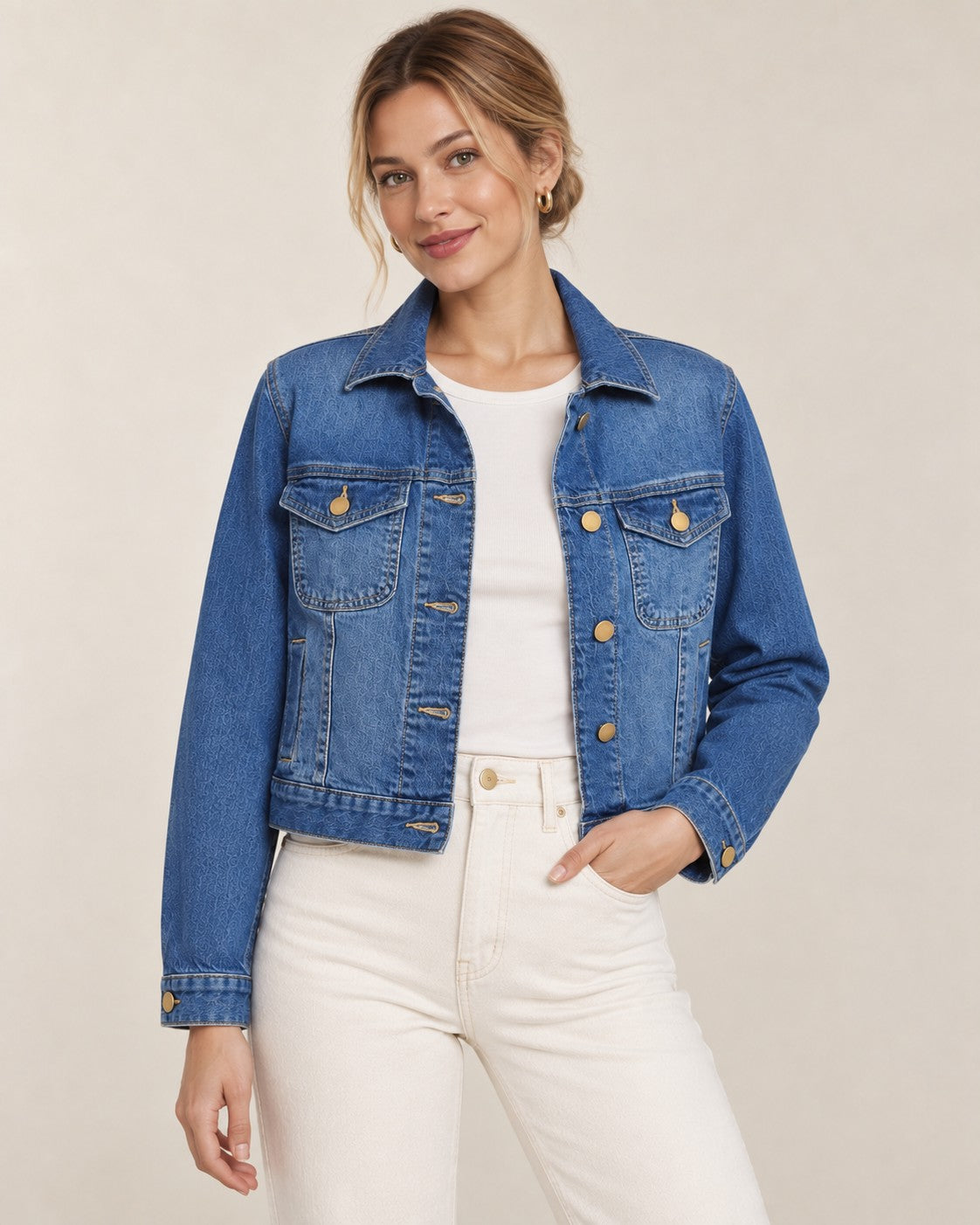 Second Soie cropped medium-wash denim jacket with gold buttons worn by a model in a studio setting