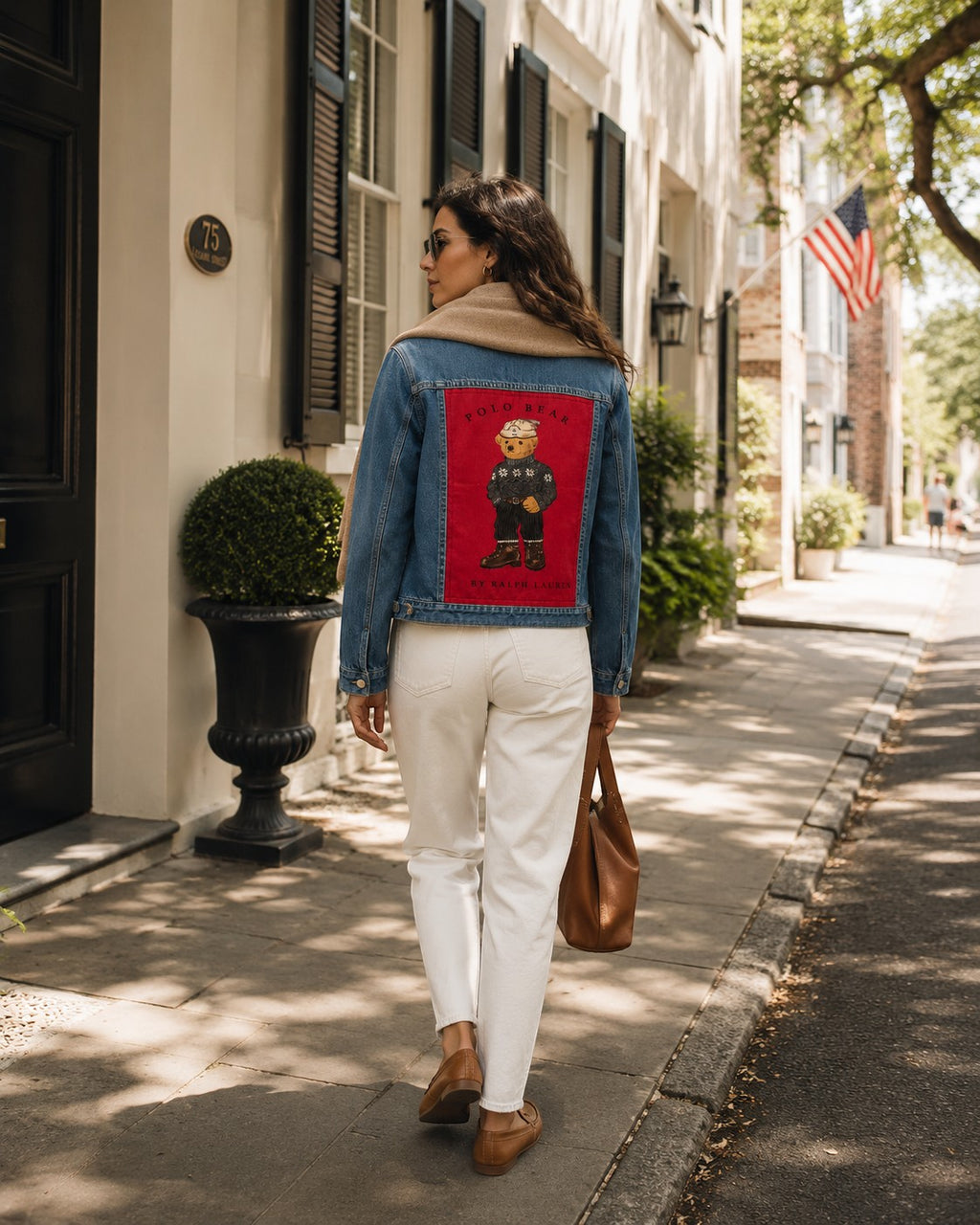 Second Soie handmade denim jacket featuring a vintage Ralph Lauren Polo Bear patch worn by a woman on a city street.