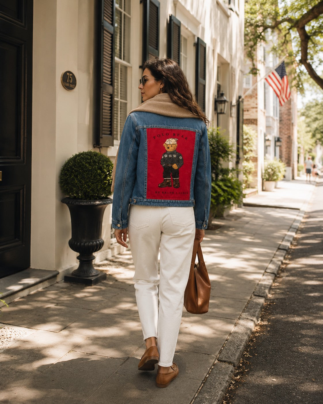 Second Soie handmade denim jacket featuring a vintage Ralph Lauren Polo Bear patch worn by a woman on a city street.