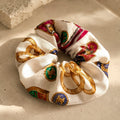 Second Soie oversized scrunchie made from a vintage Celine handkerchief with a white, gold, red, and blue print.