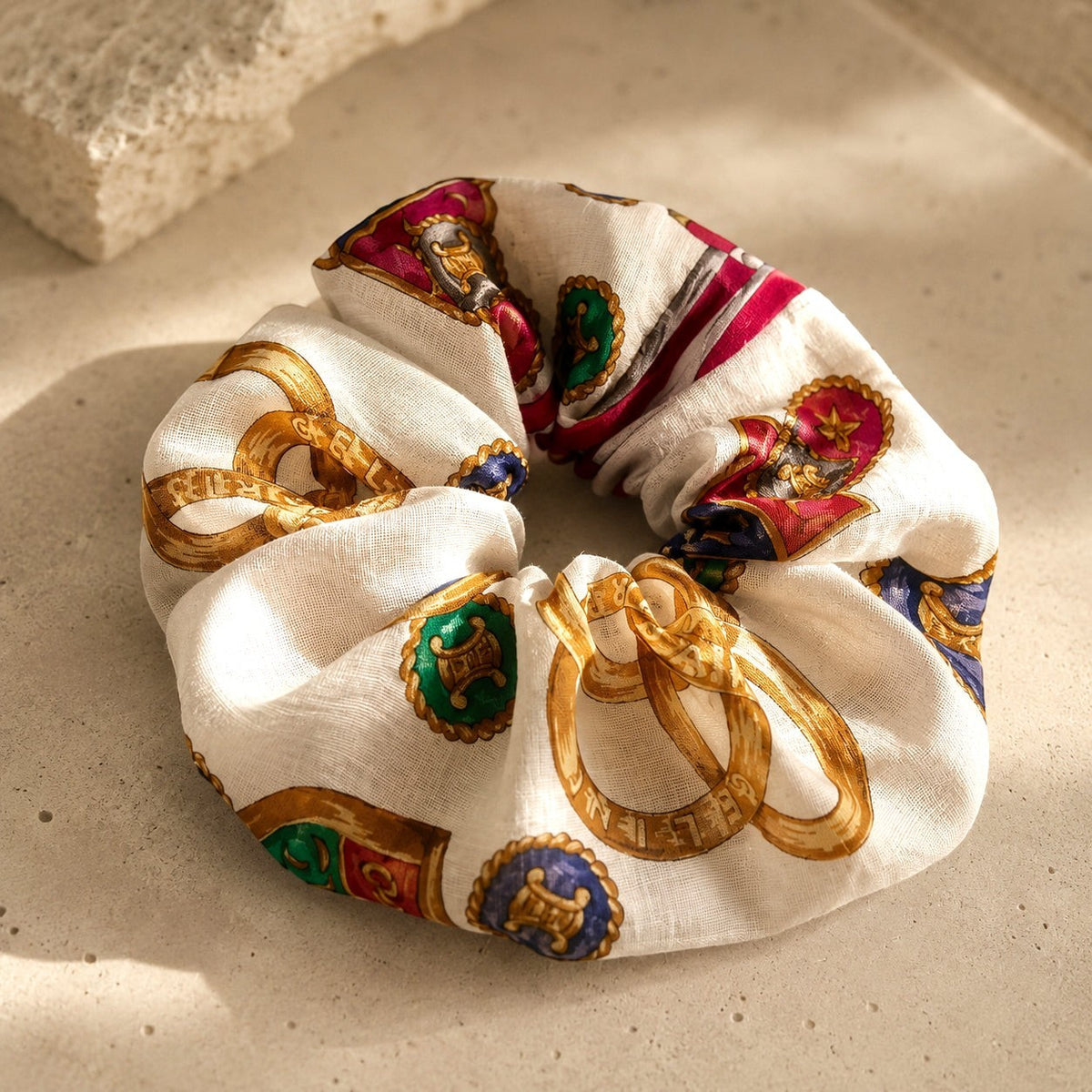 Second Soie oversized scrunchie made from a vintage Celine handkerchief with a white, gold, red, and blue print.