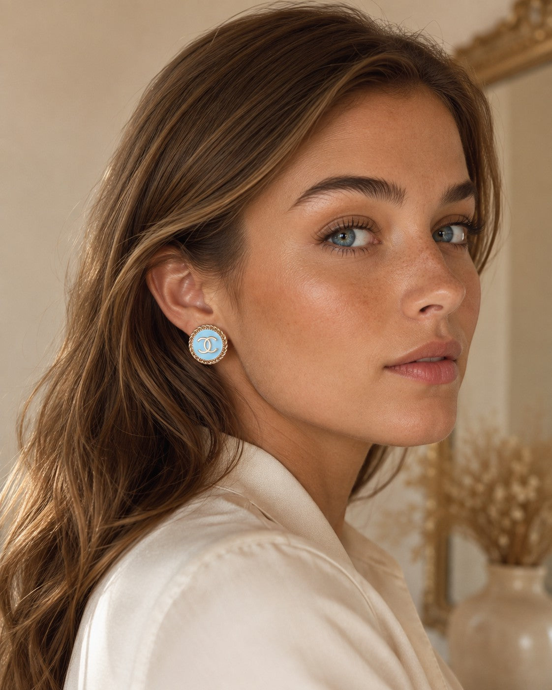 Second Soie vintage Chanel button earrings with powder blue enamel, gold CC logo, and twisted rope border on a model