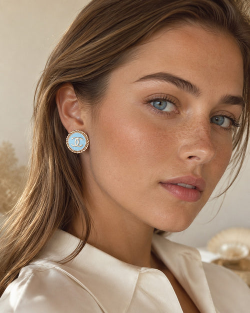 Second Soie vintage Chanel button earrings with powder blue enamel, gold CC logo, and twisted rope border on a model