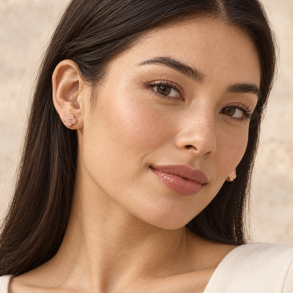 Model wearing Second Soie vintage Chanel blush-pink enamel clover stud earrings with gold-tone CC logo detail.