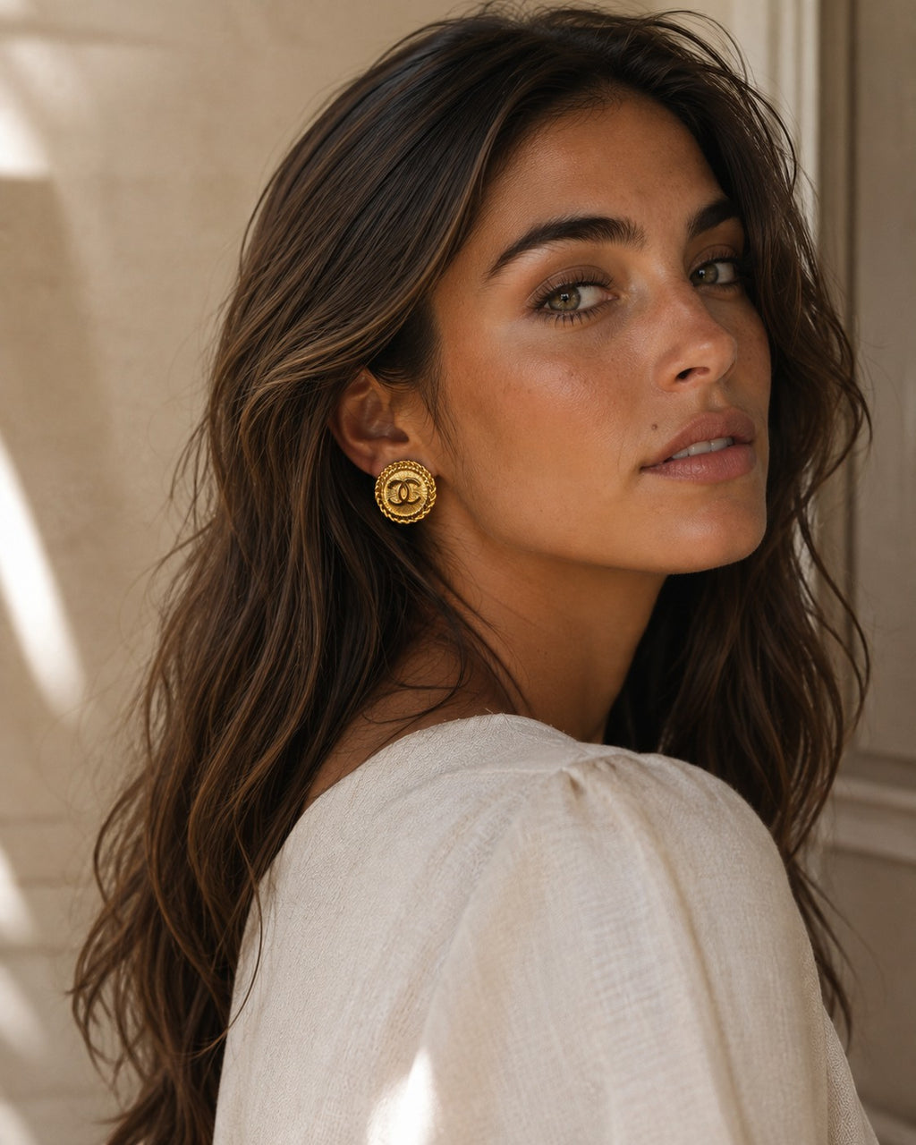 Second Soie model wearing vintage Chanel gold-tone button earrings with a rope border and iconic CC logo
