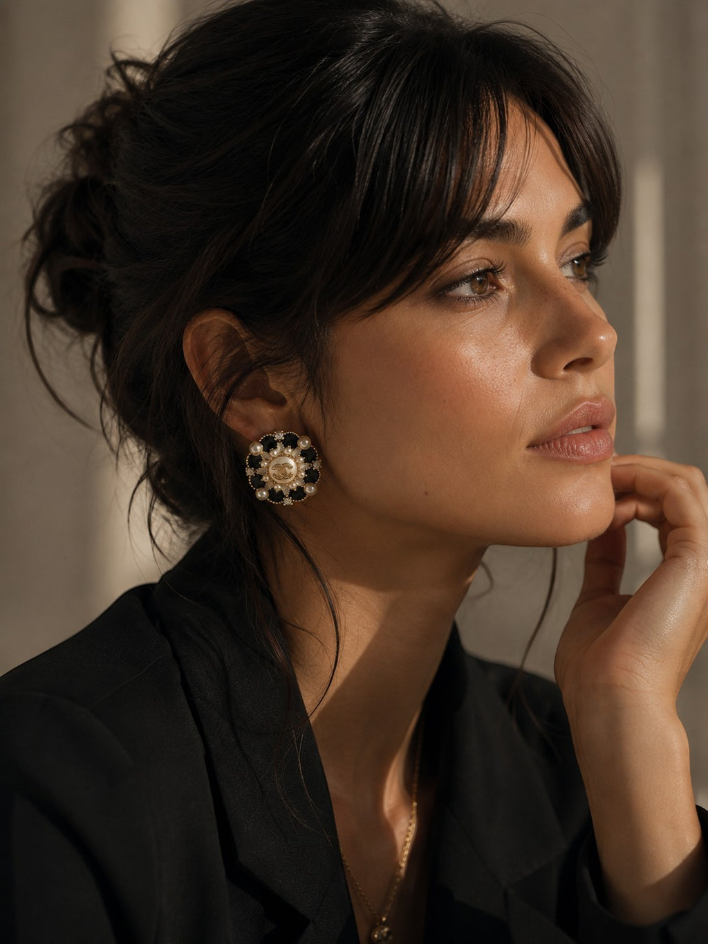 Second Soie vintage Chanel button earrings featuring black enamel, faux pearls, and gold accents worn by a model.