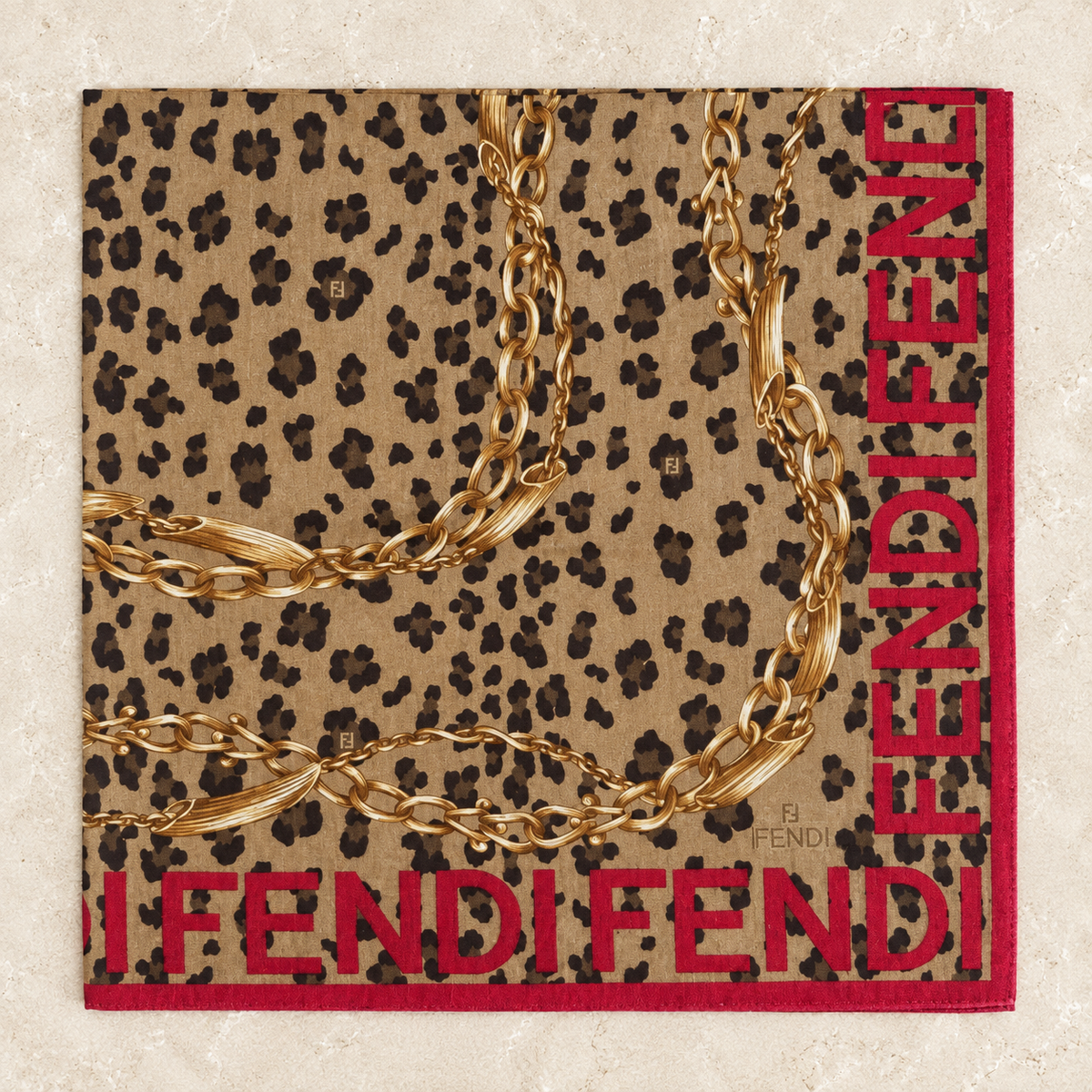 Second Soie vintage Fendi scarf featuring a tan leopard print, gold chain motifs, and bold red Fendi lettering.
