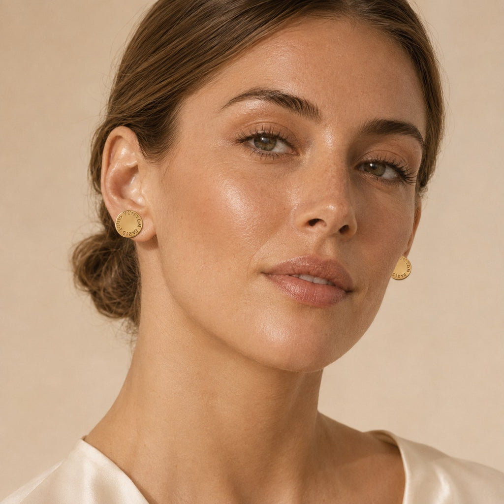 Second Soie vintage Louis Vuitton gold-tone circular stud earrings worn by a woman with a polished finish