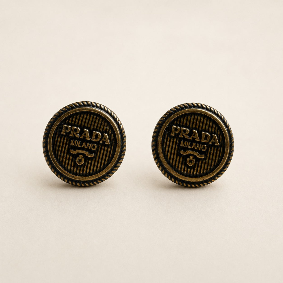 Second Soie handcrafted button earrings featuring authentic vintage Prada Milano logos in an antiqued gold-tone finish.