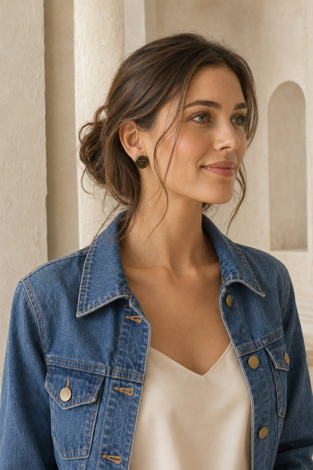 A woman wearing Second Soie handcrafted vintage Prada button earrings with an antiqued gold-tone rope border finish.
