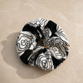 Second Soie jumbo scrunchie made from a vintage Yves Saint Laurent handkerchief with a black, ivory, and beige floral.