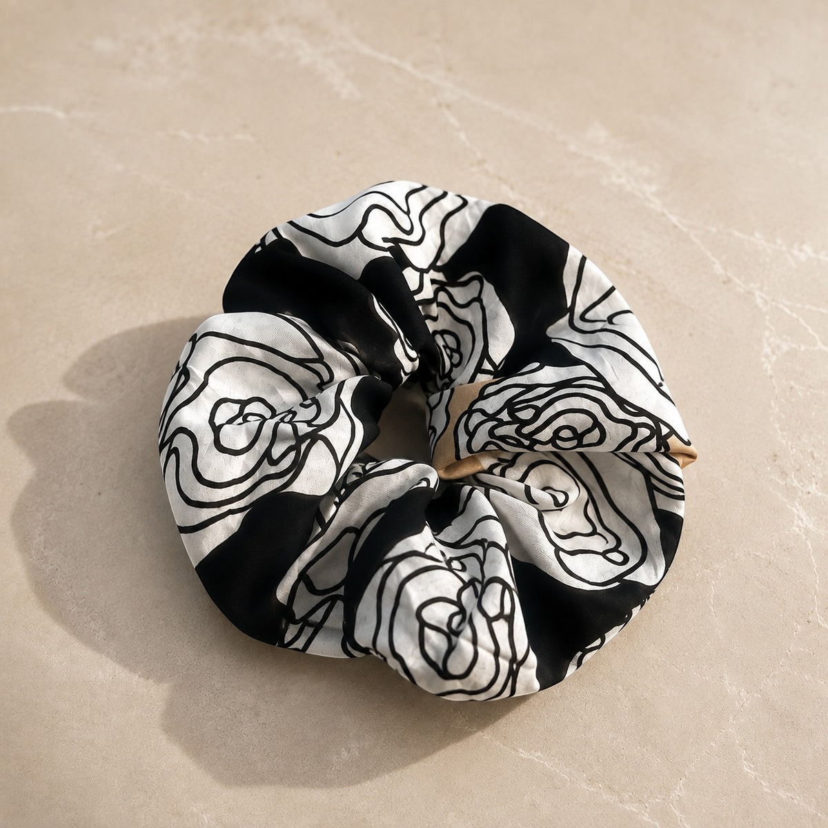 Second Soie jumbo scrunchie made from a vintage Yves Saint Laurent handkerchief with a black, ivory, and beige floral.