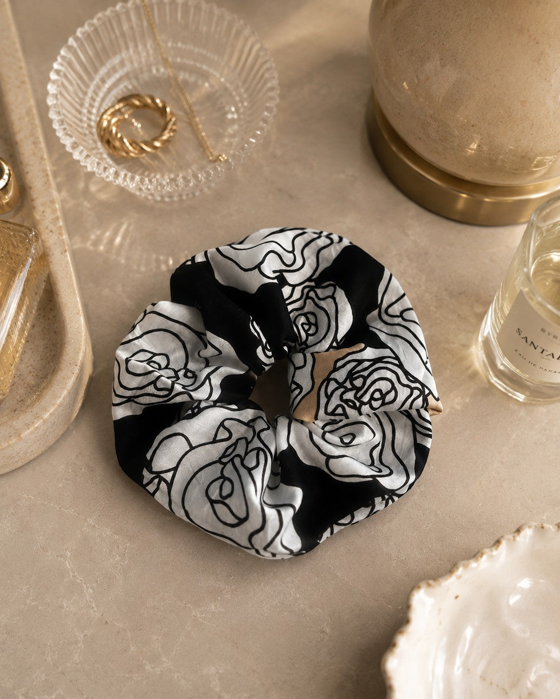 Second Soie jumbo scrunchie made from vintage YSL handkerchief with black, ivory, and beige floral pattern.