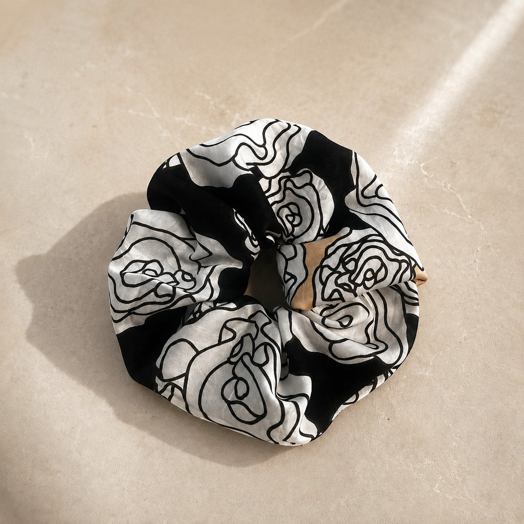 Second Soie jumbo scrunchie made from vintage Yves Saint Laurent black, ivory, and beige floral handkerchief fabric.