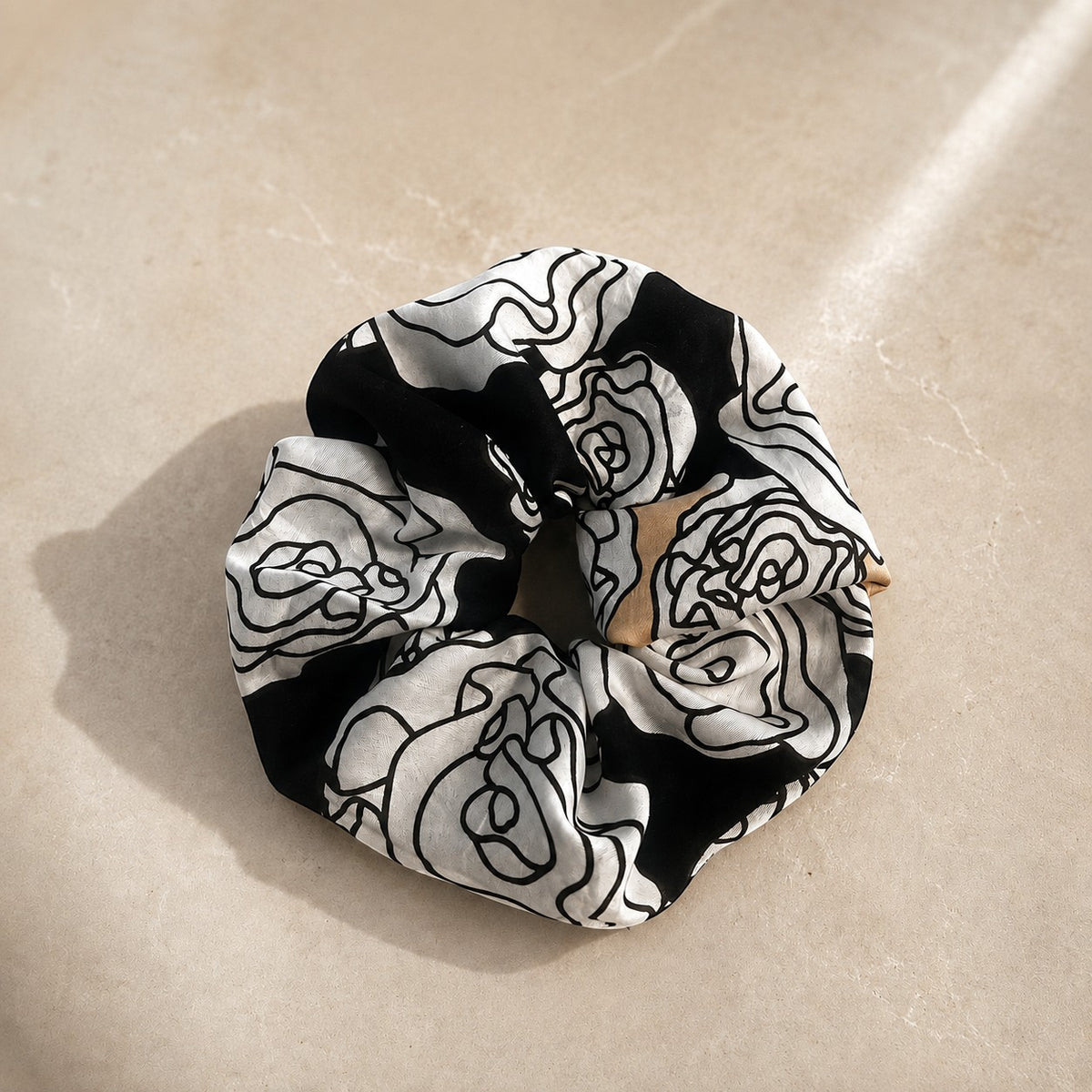 Second Soie jumbo scrunchie made from vintage Yves Saint Laurent black, ivory, and beige floral handkerchief fabric.